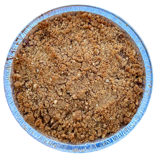 Apple crisp in a round foil pan with cinnamon oat crumble topping.