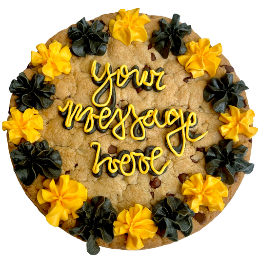 Black and gold cookie cake with custom message and piped frosting border.