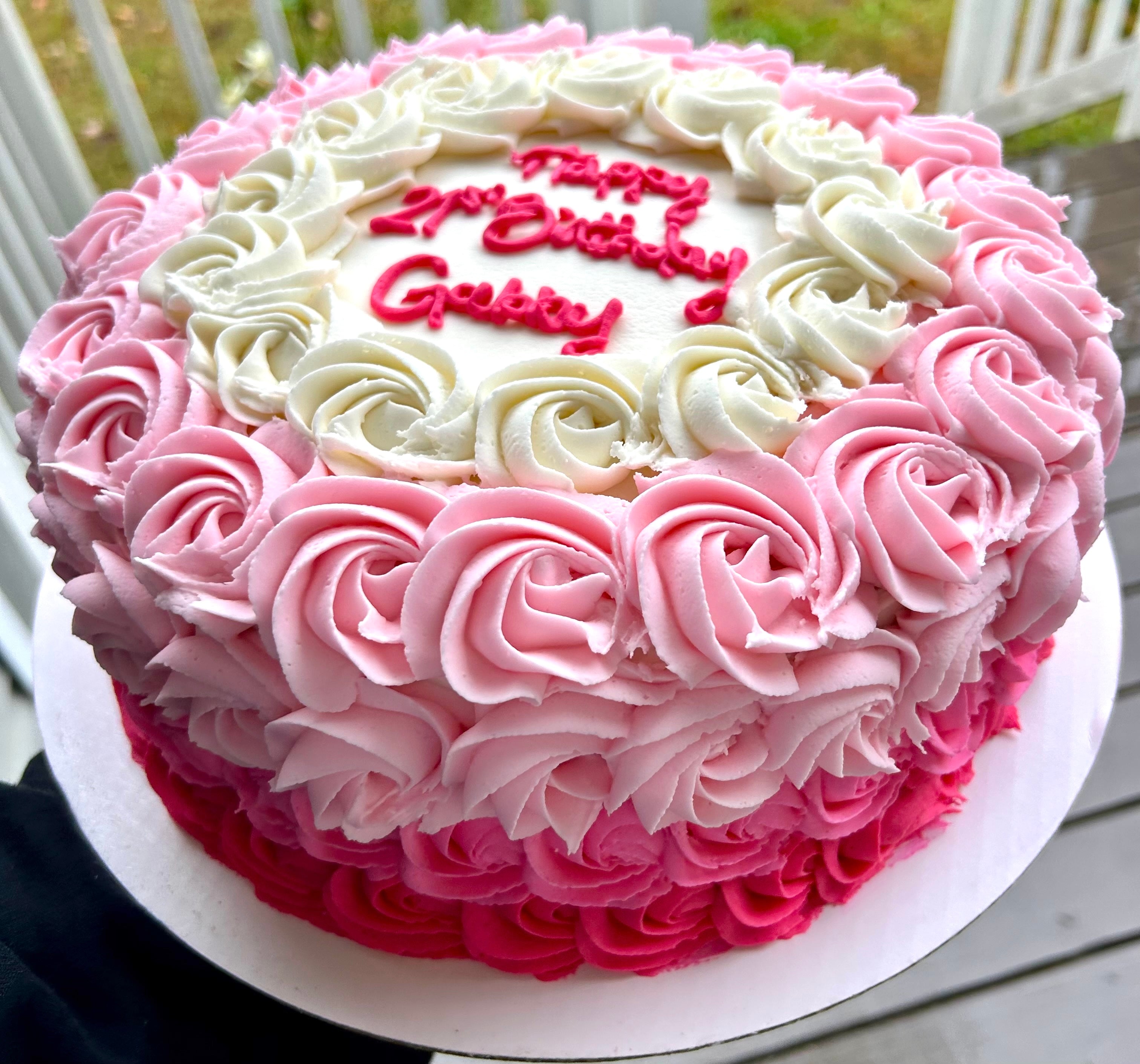 Pink and white rosette cake with 'Happy  21st Birthday Gabby' text 