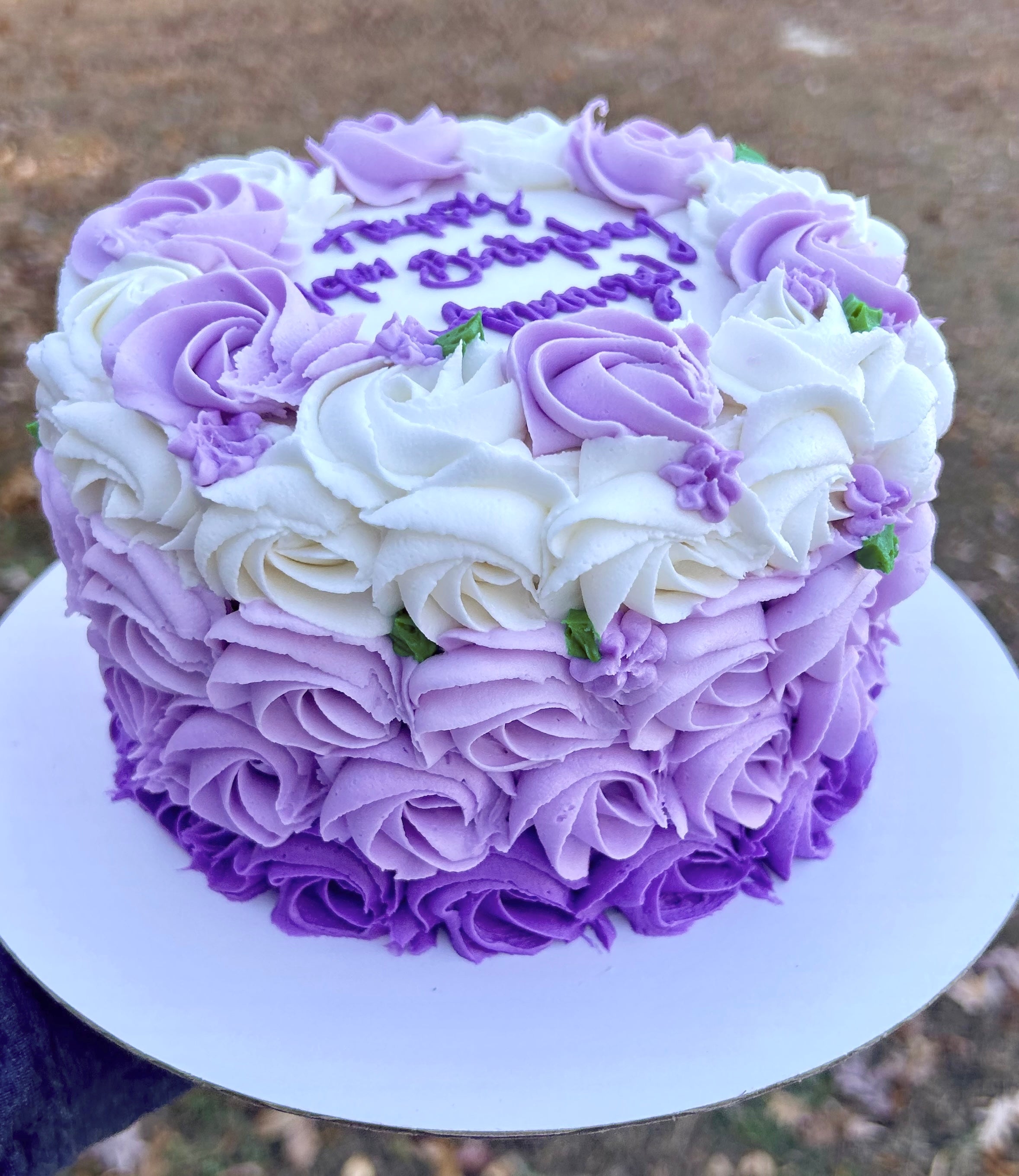 Decorative cake with purple and white rosette sides