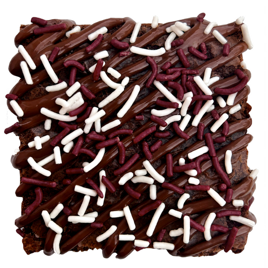 Maroon sprinkle brownie with chocolate drizzle and maroon and white sprinkles.
