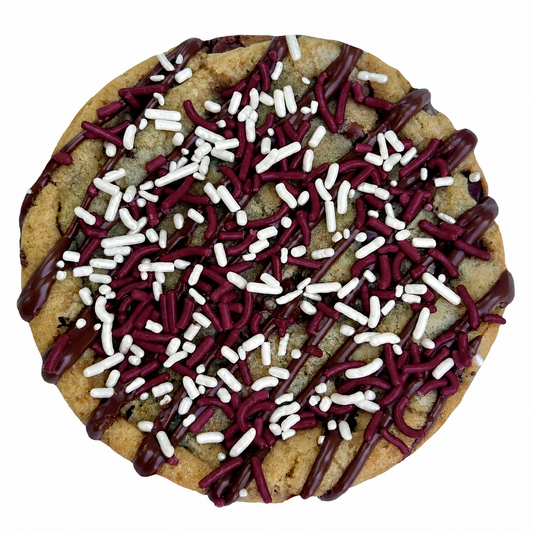 Maroon sprinkle cookie with chocolate drizzle and maroon and white sprinkles.
