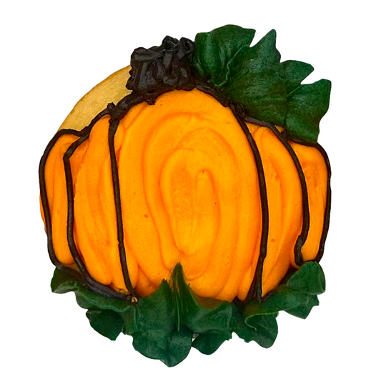 A pumpkin-frosted cupcake decorated with orange frosting and green frosting leaves.