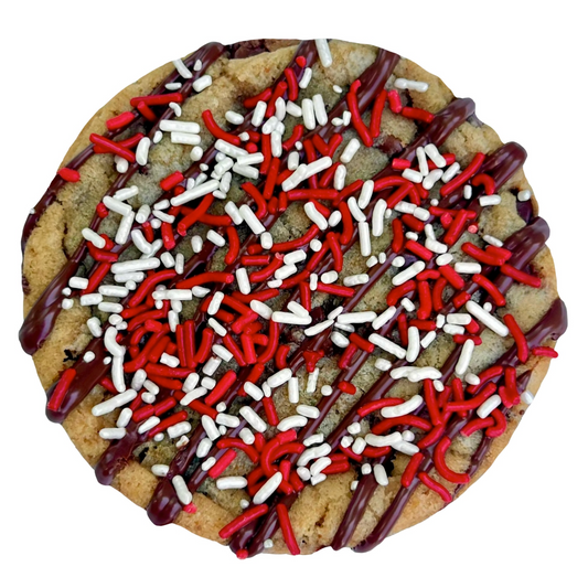 Red sprinkle cookie with chocolate drizzle and white and red sprinkles.
