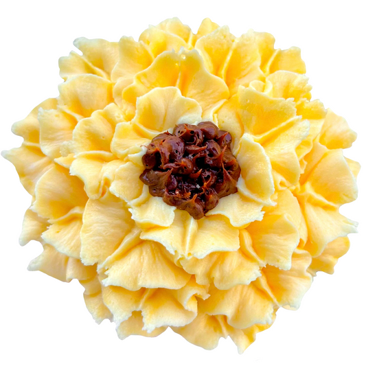 A cupcake topped with buttercream frosting designed to look like a sunflower with yellow petals and a brown center.